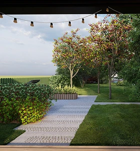 Jardín con sendero de adoquines, árboles ornamentales y luces colgantes